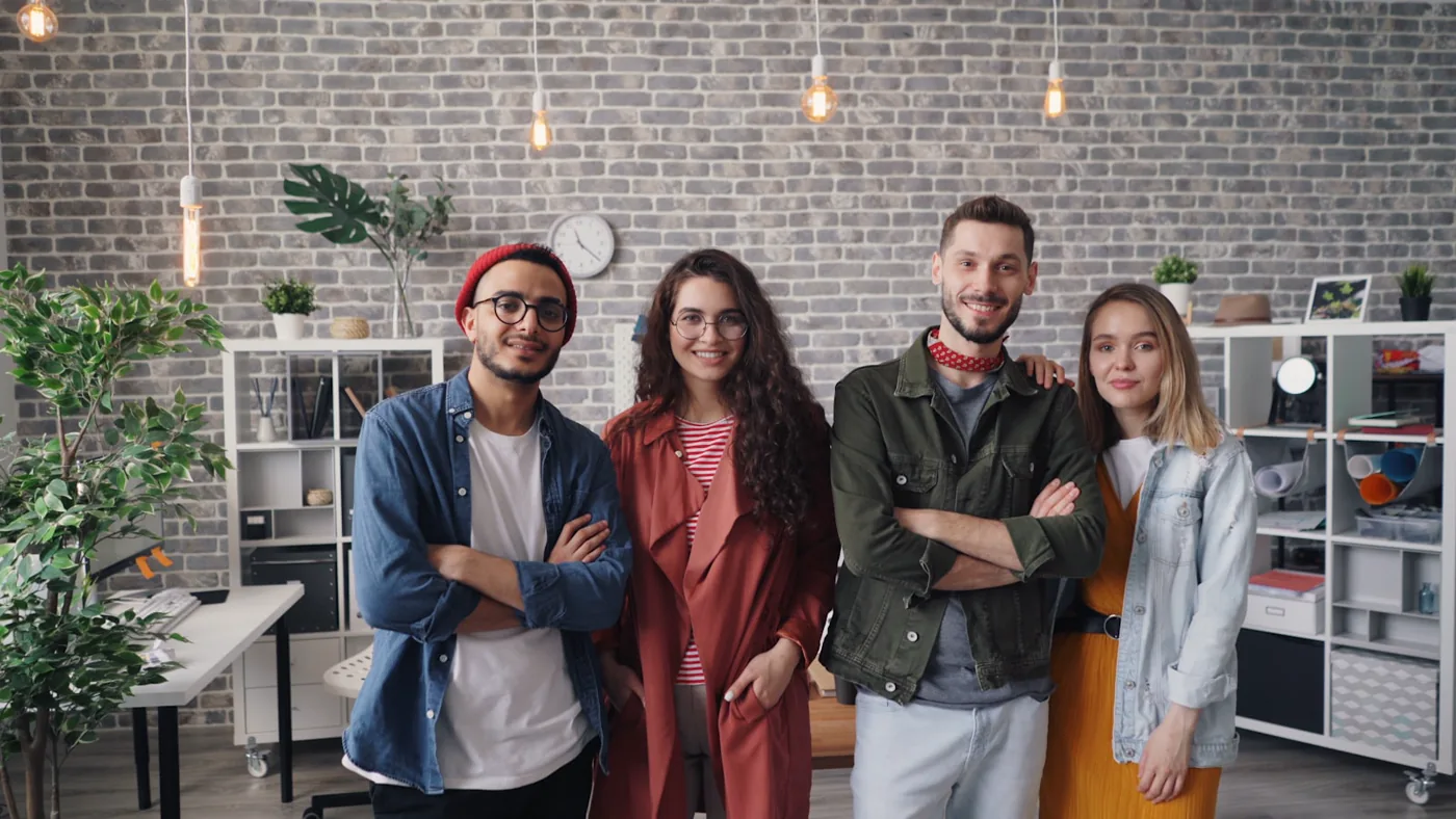 Independent business owners standing together in their shared workspace.