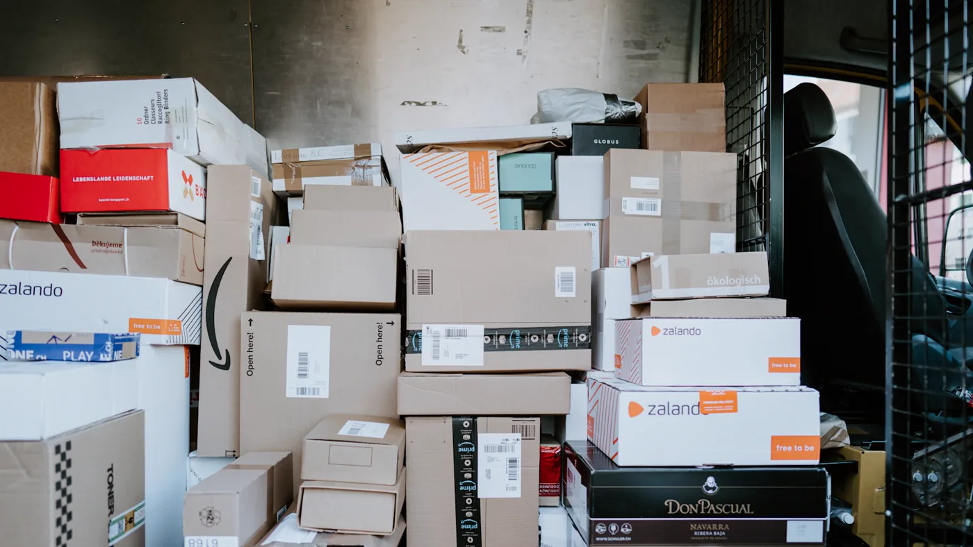 A stack of shipping boxes from many different suppliers, each in its own packaging.