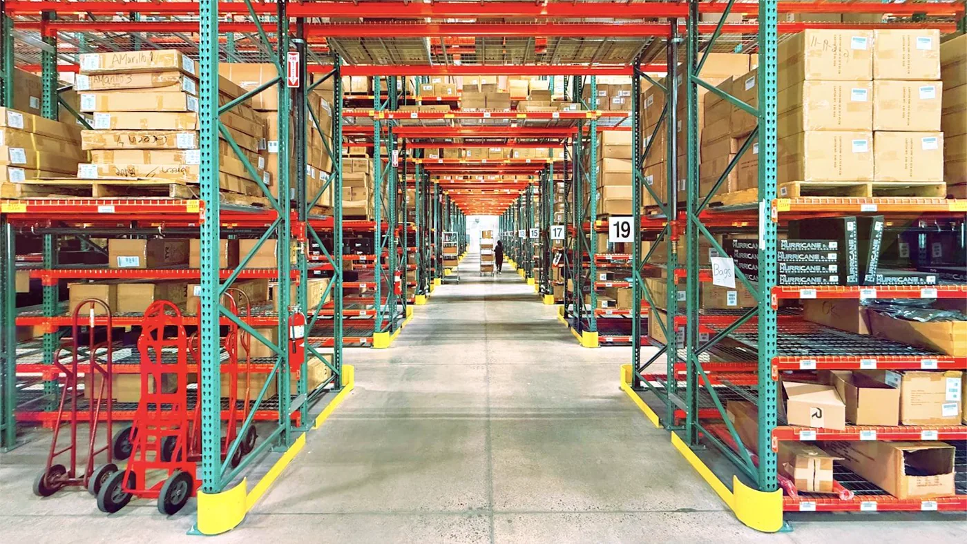 Wide warehouse aisles stocked with varied products from many suppliers.